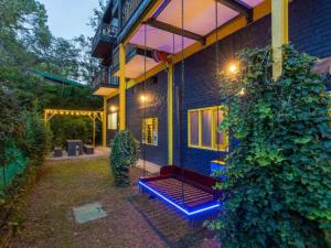 a house with a blue bench in front of it at The Hosteller Kasar Devi in Almora