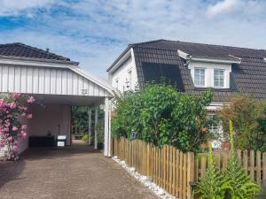 a house with a wooden fence next to a building at Ferienhaus Malmö in Tessin