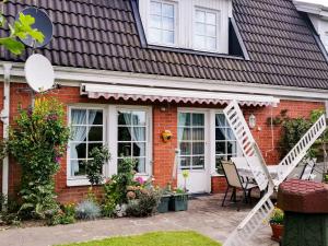 a red brick house with a white awning at Ferienhaus Malmö in Tessin