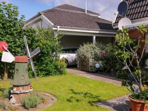 a house with a windmill in the yard at Ferienhaus Malmö in Tessin