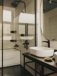 a bathroom with a sink and a tub and a mirror at Brassbell l DT l Hannaux l Tahrir sq in Cairo +37 photos