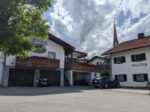 a building with a motorcycle parked in a parking lot at Gästehaus Kleisner in Innsbruck