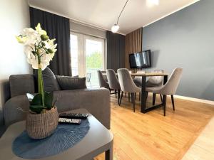 a living room with a couch and a table at Uniwersytecki by Rentoom in Toruń