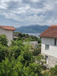 a view of the water from between two buildings at Vila Andja, Apartmani i Sobe in Krašići