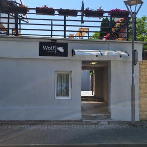 a building with a sign that says wolf on it at Pension Wolf in Gersdorf