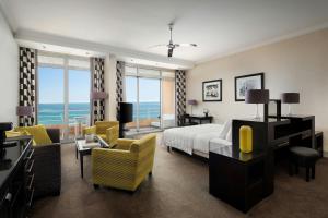 a bedroom with a bed and a living room at Le Méridien Beach Plaza in Monte Carlo