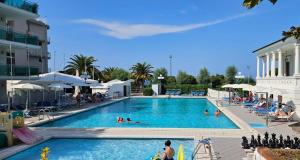 a large swimming pool with people in a resort at Playa-degli-Angeli-LEVANTE in Gabicce Mare