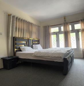 A bed or beds in a room at The Indus Escape