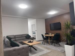a living room with a couch and a table at Apartman Booem in Bihać