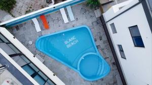 a swimming pool with a blue bench on the side of a building at Gangneung Blanc Beach Pension in Gangneung