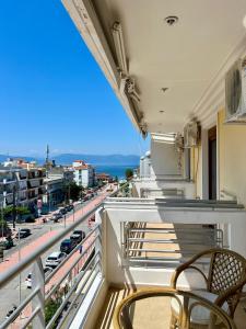 a balcony with two chairs and a view of a city at Hotel Magnolia in Loutra Edipsou