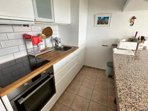 a small kitchen with a sink and a counter at Roca Negra in Puerto del Carmen