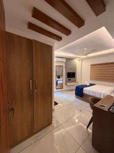a hotel room with a bed and a desk at Pepper Coast Luxury Business Hotel in Cochin