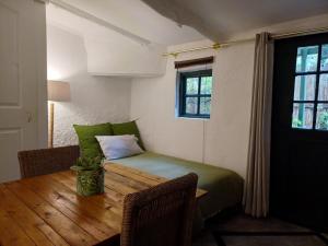 a small room with a table and a bed at The Farmhouse B&B in Stellenbosch +35 photos