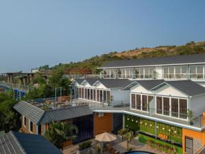an aerial view of a building with houses at The Hosteller Goa, Mandrem in Mandrem +15 photos
