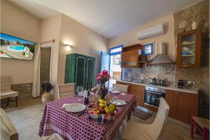 a kitchen with a table with fruit on it at Tenuta Apollonio Pool & Relax - Happy Rentals in Carpignano Salentino