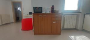 a room with a wooden cabinet with a television on it at Casa San Giovanni, apartment in the center in Borgomanero