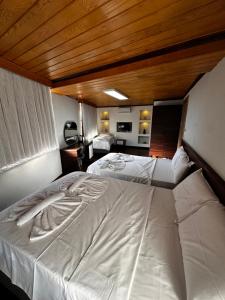 A bed or beds in a room at Gold Corner Hotel