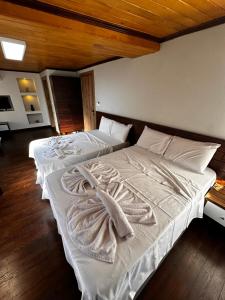 A bed or beds in a room at Gold Corner Hotel