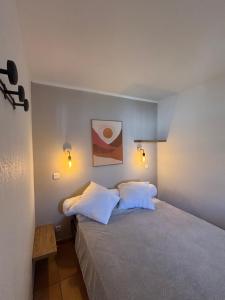 a bedroom with a bed with two white pillows at Appartement de vacance in Uhart-Cize +11 photos