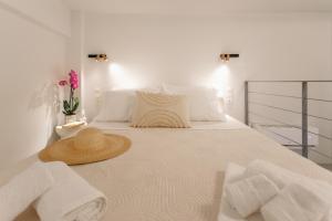 a white bed with a hat and towels on it at Agnes Loft at Campiello in Corfu