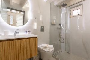 a bathroom with a shower and a toilet and a sink at Agnes Loft at Campiello in Corfu +20 photos