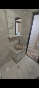 a bathroom with a sink and a mirror at david apart in Makhinjauri +11 photos