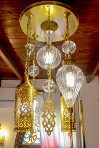 a bunch of glass chandeliers hanging from a ceiling at Sultana Downtown Cairo Hot Tub Retreat in Cairo +36 photos