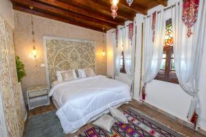 a bedroom with a white bed in a room at Sultana Downtown Cairo Hot Tub Retreat in Cairo