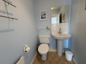 a bathroom with a toilet and a sink at Sunrise Bay - Mount Brioni in Downderry +13 photos