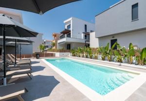 a swimming pool in front of a house at Diamond D2 Iraklitsa in Iraklitsa