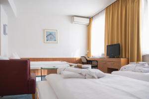 Katil atau katil-katil dalam bilik di Dom-Hotel
