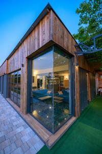 a glass extension to a building with a patio at Vila Natalijina Ramonda in Banja Luka
