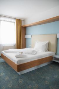 Katil atau katil-katil dalam bilik di Dom-Hotel