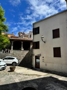 a white car parked in front of a building at Casa Del Telegrafo in Labin