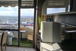 a room with a balcony with a view of a city at Let's RelaxX 1703 in Mülheim an der Ruhr