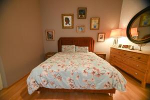 a bedroom with a bed and a dresser and a mirror at Exclusive Apartment in Vienna