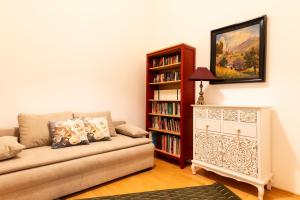 a living room with a couch and a book shelf at Exclusive Apartment in Vienna