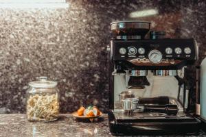 a coffee machine sitting on a counter with a jar of food at Exclusive Apartment in Vienna