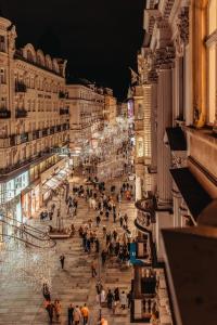 a crowd of people walking down a street at night at Exclusive Apartment in Vienna