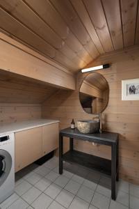 a bathroom with a washing machine and a table at 4-Bedroom Ski-In Family Cabin at Geilolia hyttetun in Hol