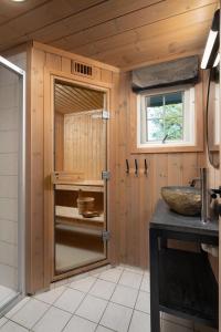 a bathroom with a sink and a mirror at 4-Bedroom Ski-In Family Cabin at Geilolia hyttetun in Hol
