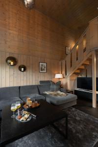 a living room with a couch and a table at 4-Bedroom Ski-In Family Cabin at Geilolia hyttetun in Hol