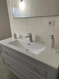 a bathroom with a white sink and a mirror at Trabzon rize in Of