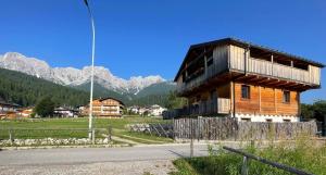 a wooden building with a balcony on the side of a road at Chalet AVE in Padola