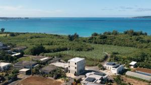 an aerial view of a city and the ocean at villa irifi 夕陽を望むヴィラ in Miyako Island