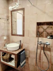 a bathroom with a sink and a shower at Maroudas Traditional Guest House in Vathi +12 photos