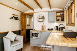 a kitchen with a counter and a chair in a room at The Bell Inn, Ladbroke in Ladbroke
