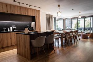 a kitchen and dining room with a bar and chairs at Max Relax SUMMERCARD INCLUDED Ski in-ski out in Zell am See