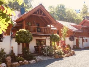a large wooden house with a balcony at Chalets-zum-Ilsetal-Carl-Lambrecht-Chalet-Nr-19 in Ilsenburg
